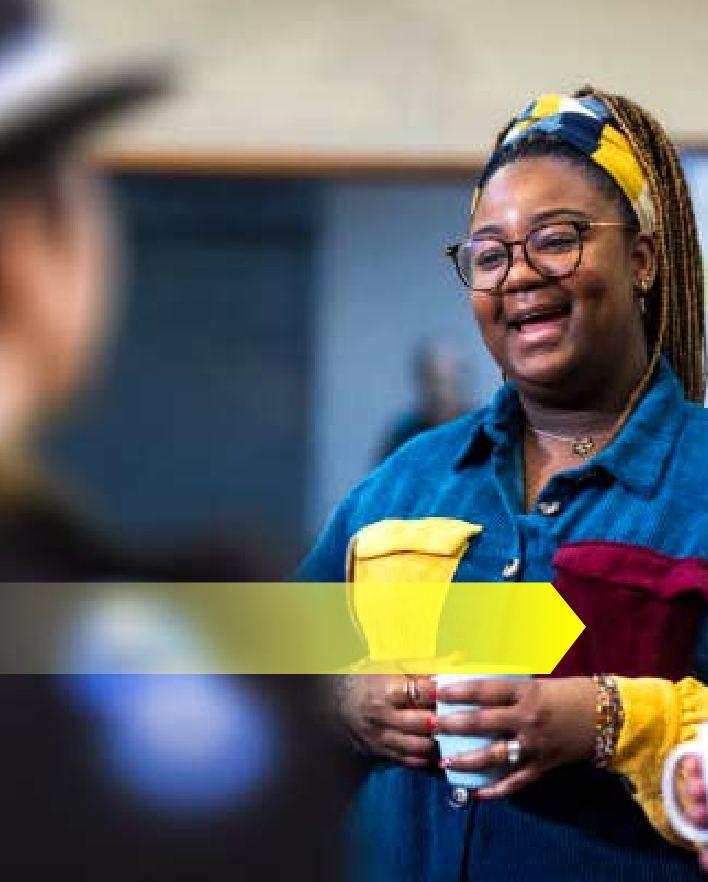 woman holding a cup and laughing